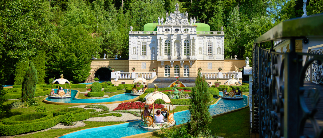 Schloss mit Bootsfahrt im blauen Kanal davor
